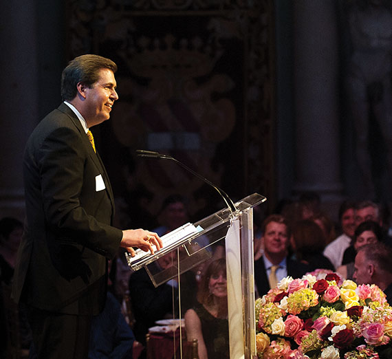 President McCulloh giving a speech with sparkling lights in the background.