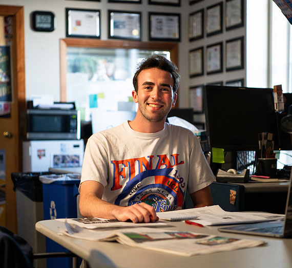 Alumna Melissa Koontz, class of 2012, sits at desk