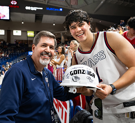 Gonzaga's mascot Spike flexs for the camera during a basketball game.